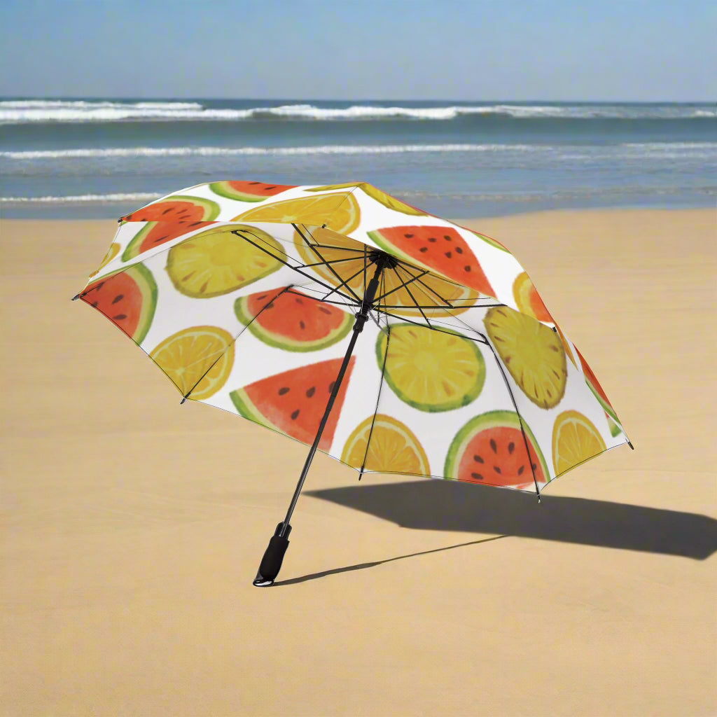 Umbrella with fruit pattern on a sandy beach